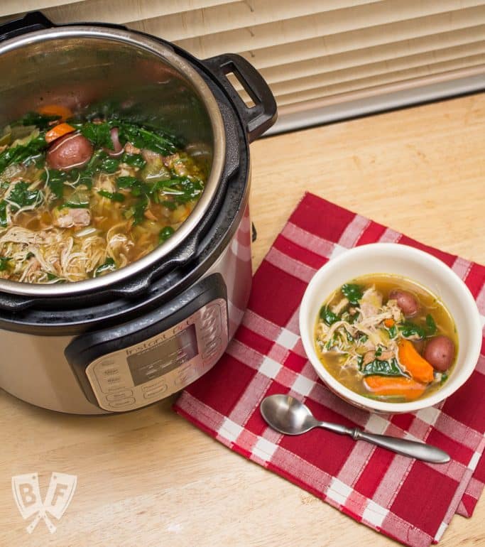 Overhead view of an Instant Pot full of soup with a bowl and spoon alongside.