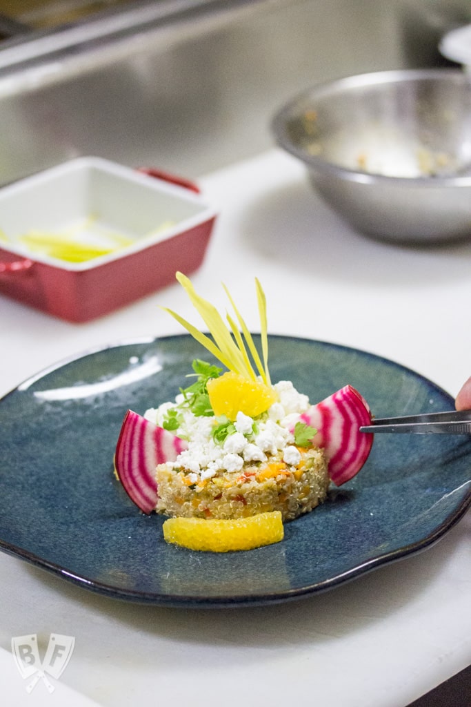 Pax Romana's Quinoa Salad with Mixed Vegetable, Goat Cheese & Orange Dressing: No more boring quinoa salad recipes! Fresh orange zest and juice go into the bold, bright vinaigrette for this beautifully plated restaurant recipe. #BigFlavorsFromARestaurantKitchen