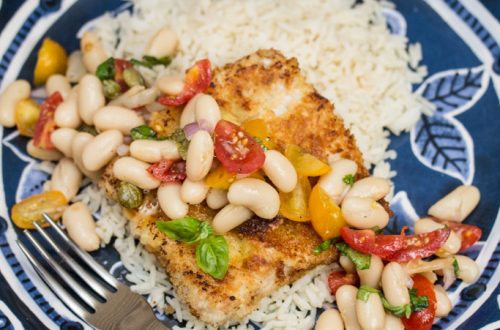 Pork Scallopini with White Bean-Tomato Salad: Need a quick weeknight dinner? Thin cut pork is coated in panko and fried till crispy, then topped with a vibrant salad that comes together in just minutes! A perfect use for canned white beans!