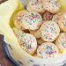 Container of ricotta cookies with tissue paper.