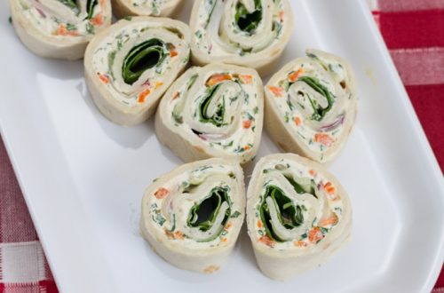 Overhead view of a platter of veggie cream cheese roll-ups.