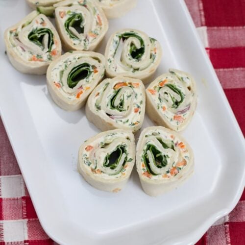 Overhead view of a platter of veggie cream cheese roll-ups.
