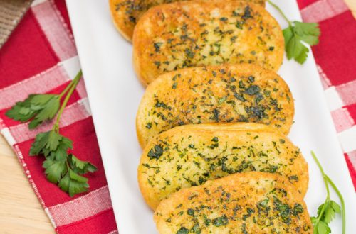 Platter of Skillet Garlic Parmesan Bread garnished with parsley.