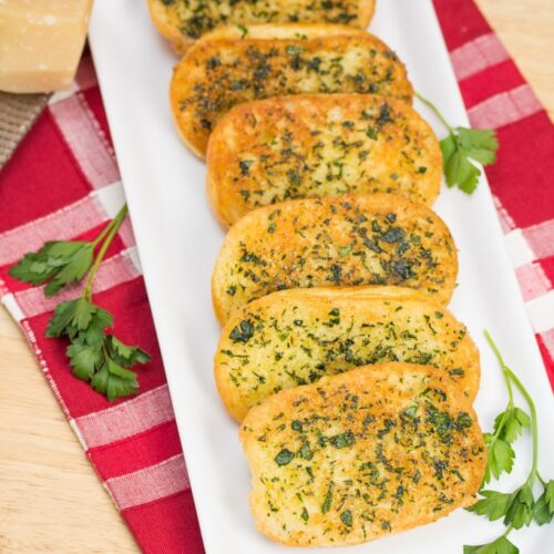 Platter of Skillet Garlic Parmesan Bread garnished with parsley.