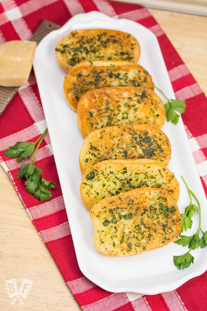 Platter of Skillet Garlic Parmesan Bread garnished with parsley.