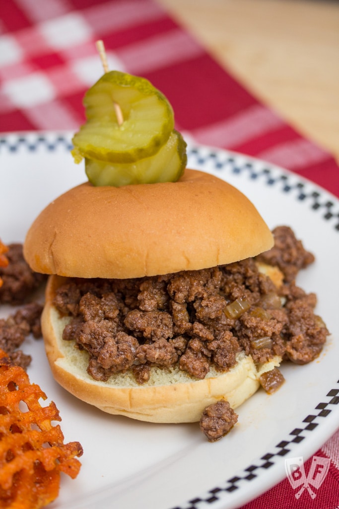 Sloppy Joe sandwich with pickles and sweet potato fries