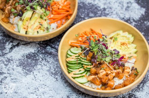 Overhead view of Spicy Salmon Poke Bowl with varied toppings