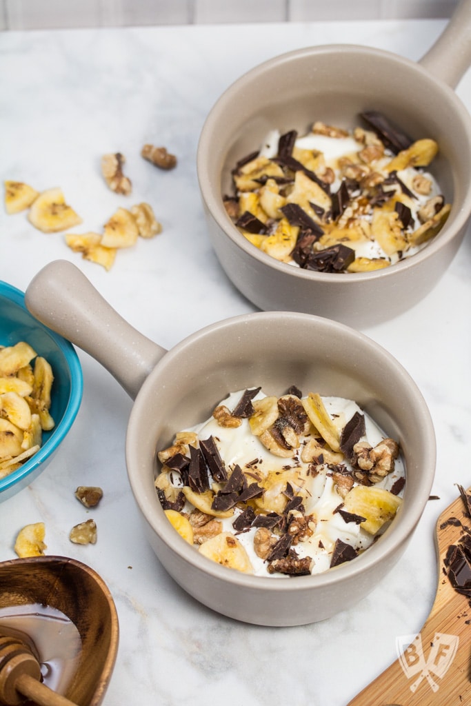 Chunky Monkey Greek Yogurt Parfaits: Chunks of premium dark chocolate, banana chips, toasted walnuts + a drizzle of honey bring these dessert-inspired breakfast parfaits to the next level! #StonyfieldBlogger #TheWholeYou #ad