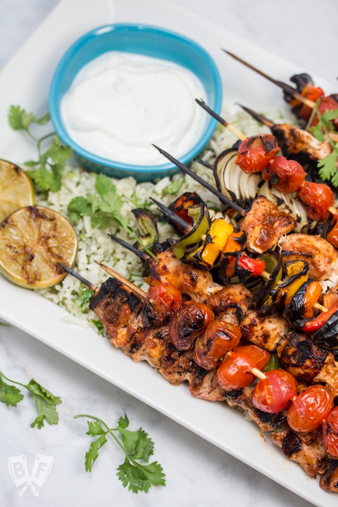 Chicken Fajita Skewers over Cilantro Cauliflower Rice: A rich, flavorful marinade makes these fajitas on a stick the perfect excuse to fire up the grill! Add a paleo side for a low carb summer meal! #OrganicMoments #ad