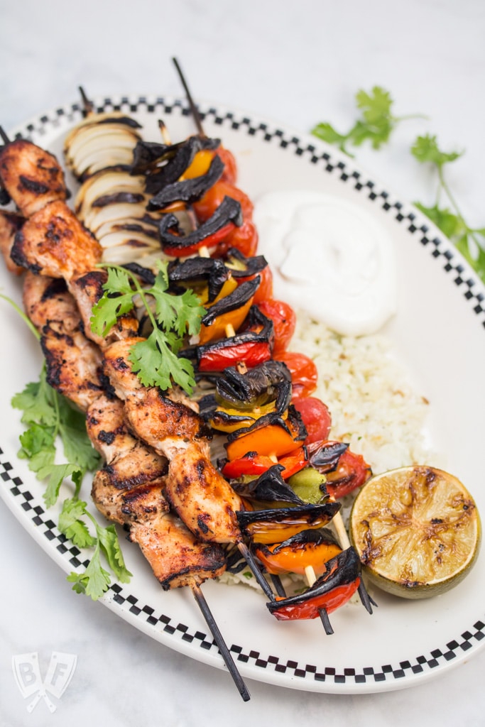 Chicken Fajita Skewers over Cilantro Cauliflower Rice: A rich, flavorful marinade makes these fajitas on a stick the perfect excuse to fire up the grill! Add a paleo side for a low carb summer meal! #OrganicMoments #ad