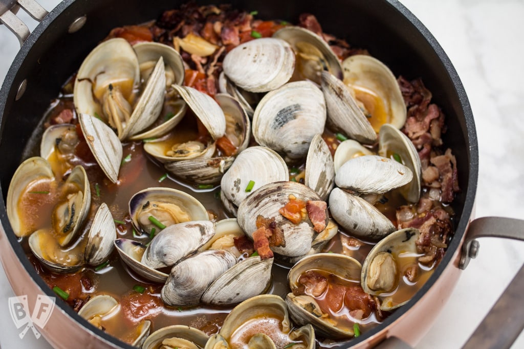 Garlicky Littleneck Clams with Bacon + Wine Over Sautéed Spring Veggies: A bed of sautéed veggies makes the perfect base for this bacon-loaded seafood dish. Make sure you have plenty of crusty bread for dunking! #BaconMonth