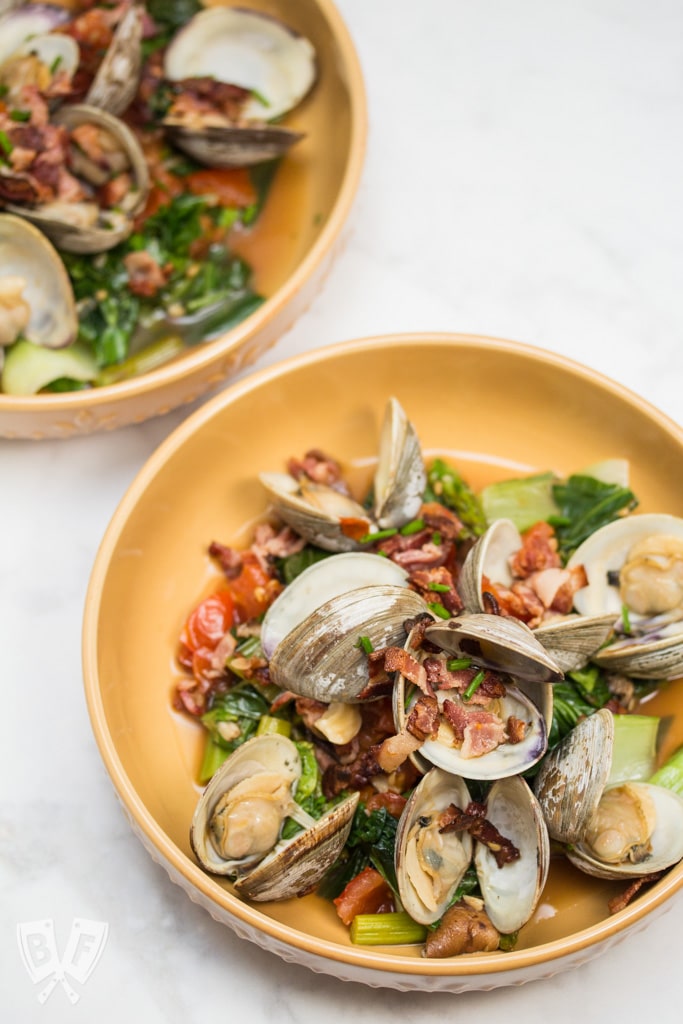 Garlicky Littleneck Clams with Bacon + Wine Over Sautéed Spring Veggies: A bed of sautéed veggies makes the perfect base for this bacon-loaded seafood dish. Make sure you have plenty of crusty bread for dunking! #BaconMonth