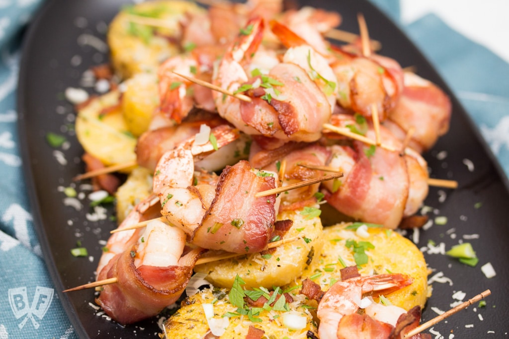 Big Shrimpin' Bacon-Wrapped Shrimp and Grit Cakes: Classic shrimp and grits gets an upscale makeover in this over-the-top, bacon-wrapped presentation. Easy, delicious, and sure to impress your dinner guests! #BaconMonth