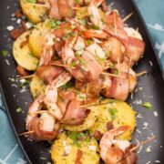 Big Shrimpin' Bacon-Wrapped Shrimp and Grit Cakes: Classic shrimp and grits gets an upscale makeover in this over-the-top, bacon-wrapped presentation. Easy, delicious, and sure to impress your dinner guests! #BaconMonth