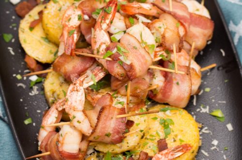 Big Shrimpin' Bacon-Wrapped Shrimp and Grit Cakes: Classic shrimp and grits gets an upscale makeover in this over-the-top, bacon-wrapped presentation. Easy, delicious, and sure to impress your dinner guests! #BaconMonth