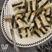 Overhead view of a plate of black and white striped sweet potato ravioli - a tribute to Beetlejuice