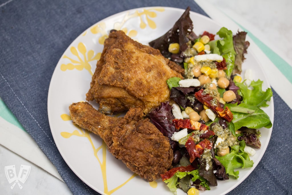 (#ad) Roma Salad with Caper-Dill Vinaigrette: Chickpeas, corn, black beans, feta cheese, + sun-dried tomatoes turn salad greens into a deliciously filling meal. Top it with a tangy homemade vinaigrette! #CookingWithCoke #CollectiveBias