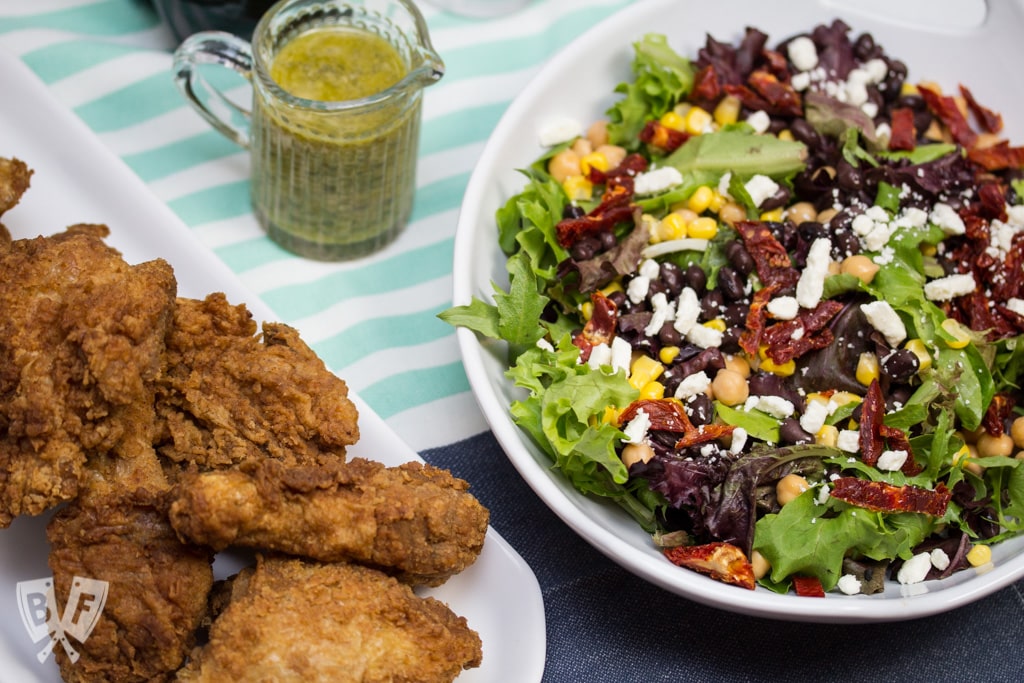 (#ad) Roma Salad with Caper-Dill Vinaigrette: Chickpeas, corn, black beans, feta cheese, + sun-dried tomatoes turn salad greens into a deliciously filling meal. Top it with a tangy homemade vinaigrette! #CookingWithCoke #CollectiveBias