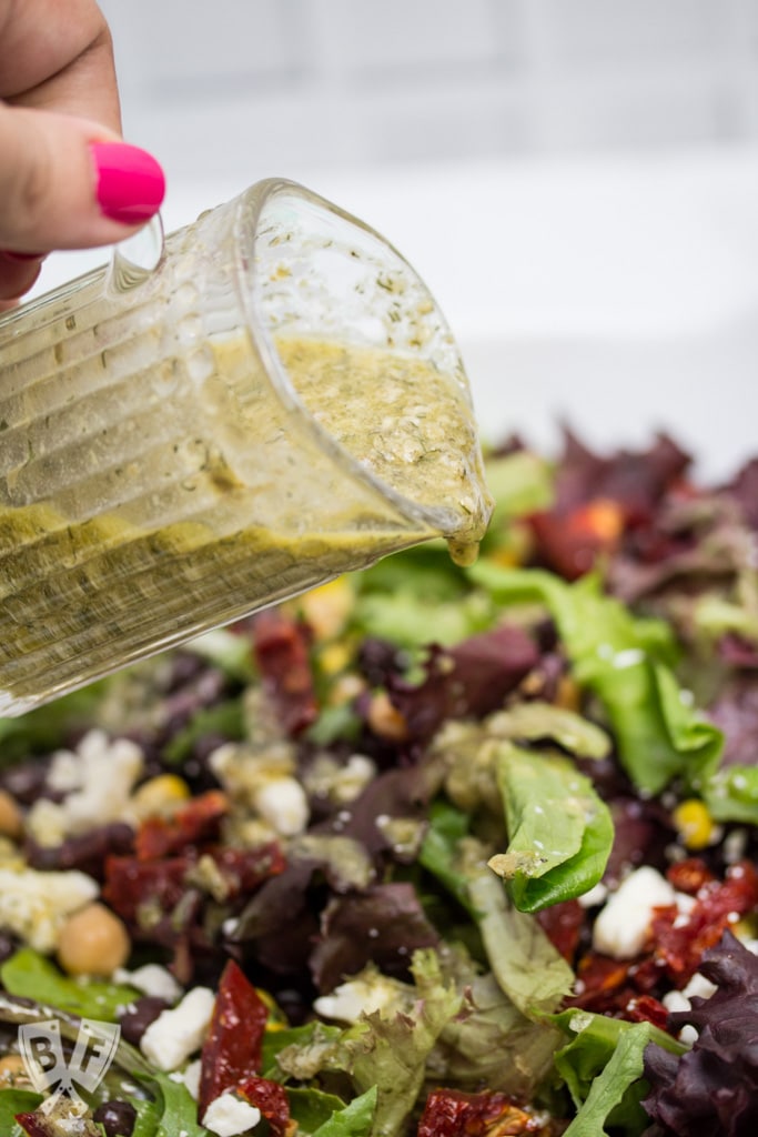 Roma Salad with Caper-Dill Vinaigrette: Chickpeas, corn, black beans, feta cheese, + sun-dried tomatoes turn salad greens into a deliciously filling meal. Top it with a tangy homemade vinaigrette! #CookingWithCoke #CollectiveBias