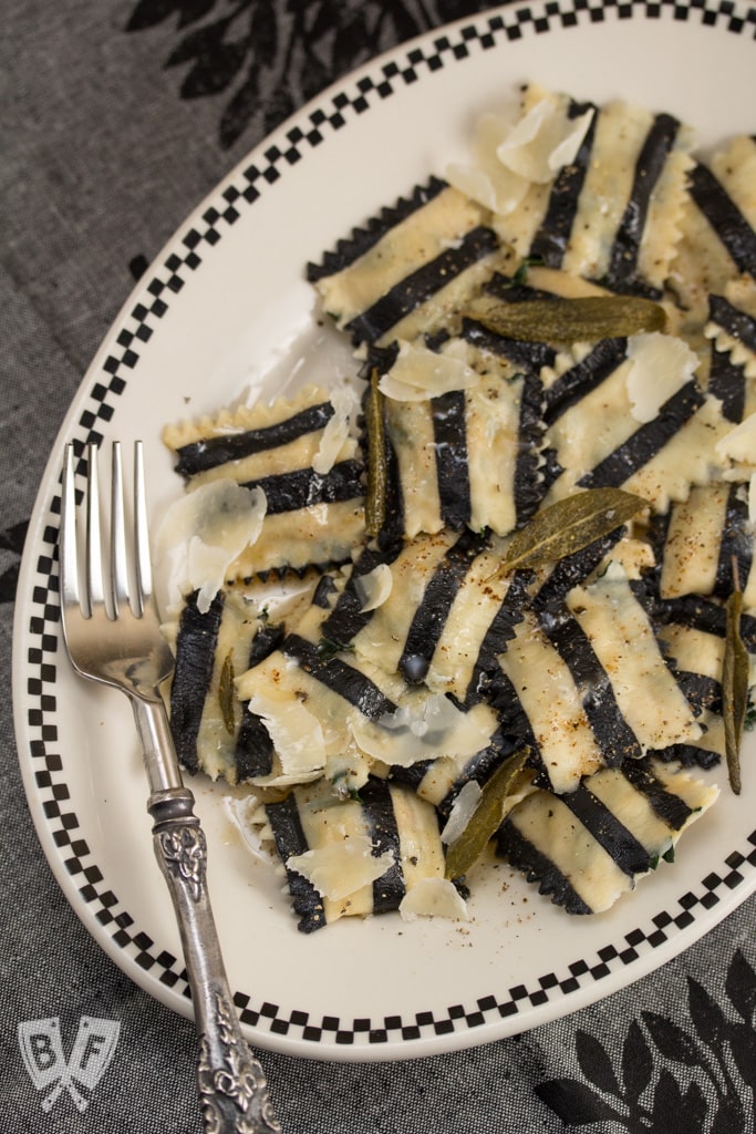 Ghost with the Most Roasted Sweet Potato Ravioli: Homemade black + white pasta is stuffed with roasted veggies, topped with brown butter sauce & crispy sage leaves in my Halloween tribute to Beetlejuice!