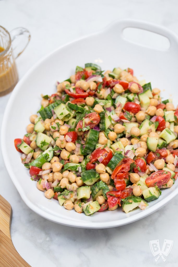 Falafel-Spiced Chickpea Salad with Tahini-Lemon Vinaigrette (#ad): This quick, simple Middle Eastern salad + homemade pita chips brings all the flavor of falafel in a fraction of the time - no deep frying required! #snackwithbarleans