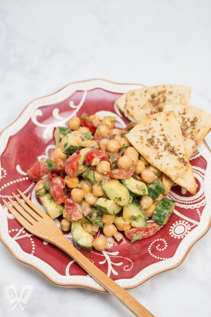 Plate of Falafel-Spiced Chickpea Salad with Tahini-Lemon Vinaigrette and a fork.