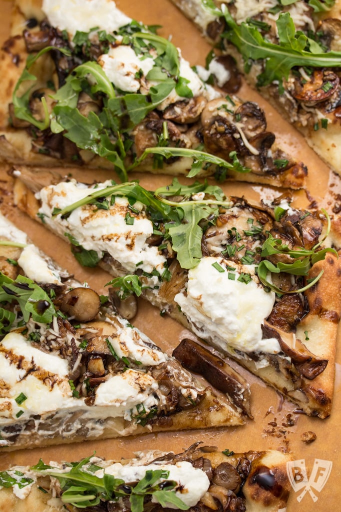 Garlicky Mushroom Ricotta Pizza with Wild Arugula + Aged Balsamic: Sautéed mushrooms are topped with ricotta and Parmesan cheeses and baked into a store-bought pizza crust for an easy, elegant weeknight meal!