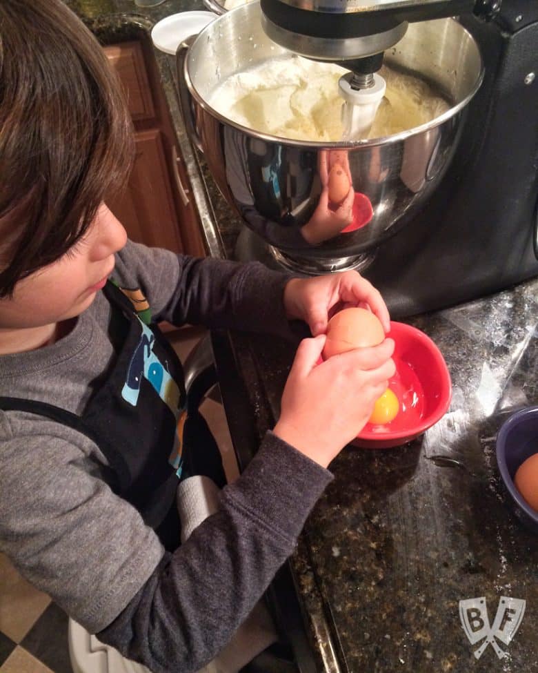 A child making cookie dough in the kitchen.
