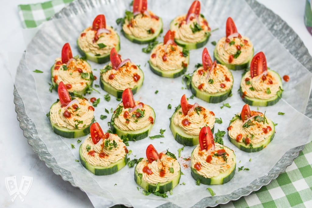 Platter of cucumber slices topped with a spiced chickpea purée.