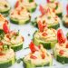 Close up of a few cucumber slices topped with a spiced chickpea purée.