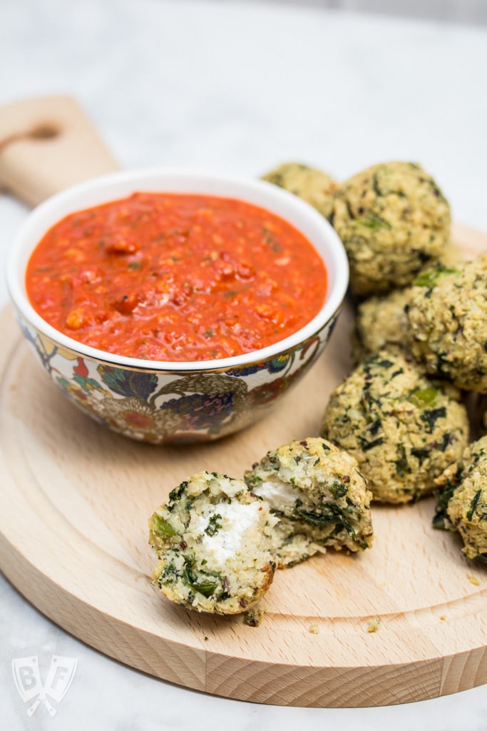 Goat Cheese-Stuffed Quinoa & Kale Balls with Romesco Sauce: (#ad) This hearty goat cheese-stuffed vegetarian "meatball" recipe with quick romesco sauce makes an elegant party appetizer or main course for Meatless Monday!