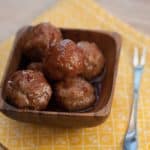Meatballs in a small dish with a fork.