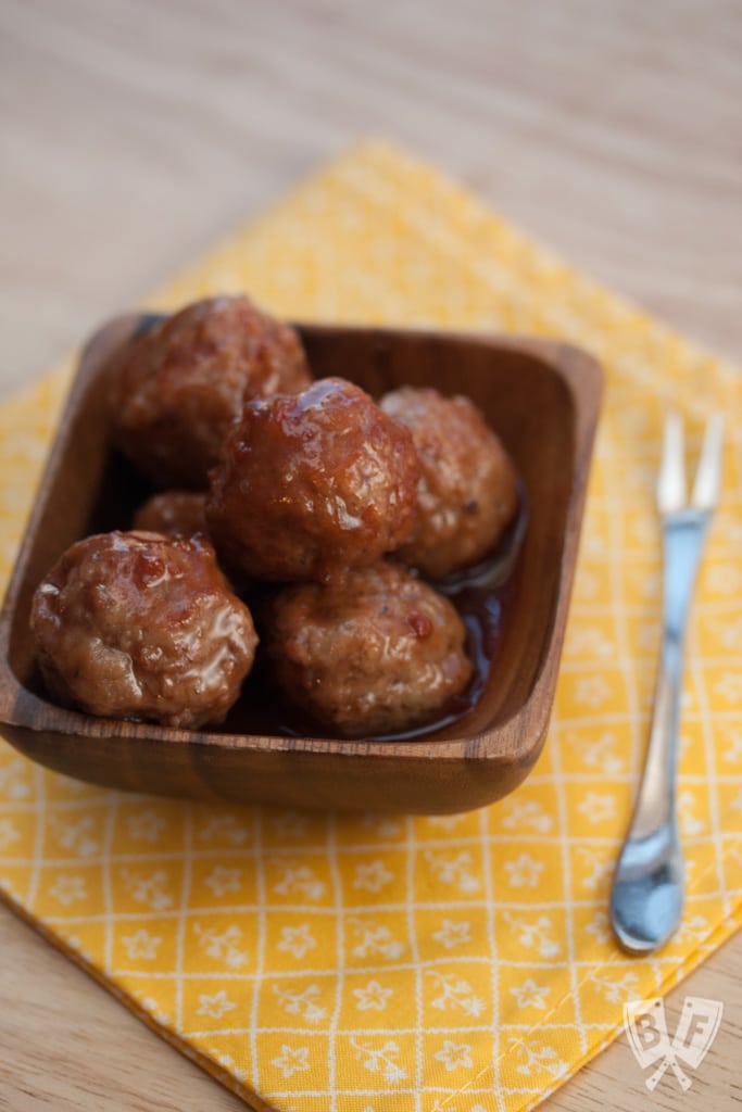 Meatballs in a small dish with a fork.