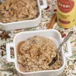 Bowls of ashwagandha chai porridge with spoons and whole spices alongside.