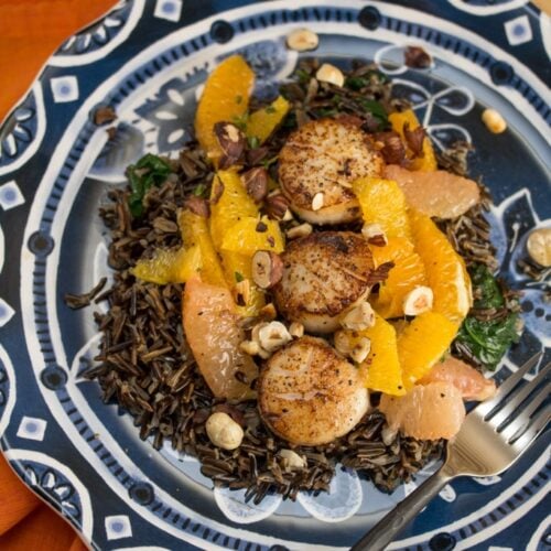 Seared Scallops with Citrus Trio + Wild Rice on a plate.