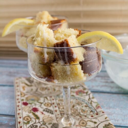Lemon cake cut into cubes in wine glasses.