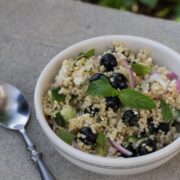 A bowl of blueberry and feta bulgur salad with mint.