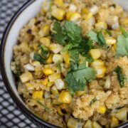 A bowl of grilled corn and cheddar quinoa with cilantro.