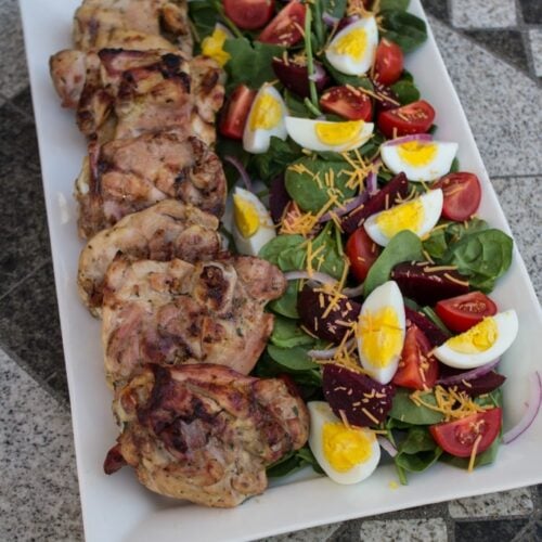Hidden Valley Ranch Country Marinade Grilled Chicken on a platter with salad.