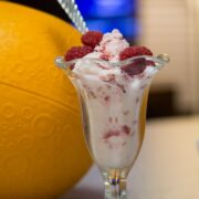 Ice cream sundae glass filled with 3 Ingredient Raspberry Frozen Yogurt.