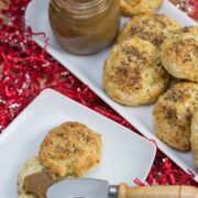 Banana scones on a platter with a jar of banana orange curd.