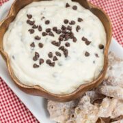 Overhead view of cannoli dip in a bowl with chips alongside.