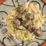 Plate of meatball stroganoff over noodles.