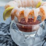 Shrimp cocktail displayed on a glass with ice.