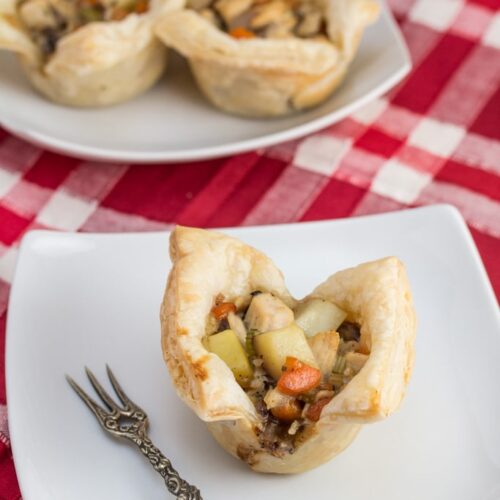 Mini Turkey Pot Pies with Puff Pastry on serving plates.