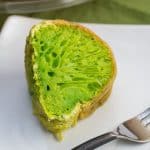 A slice of vibrant green Vietnamese honeycomb cake on a plate.