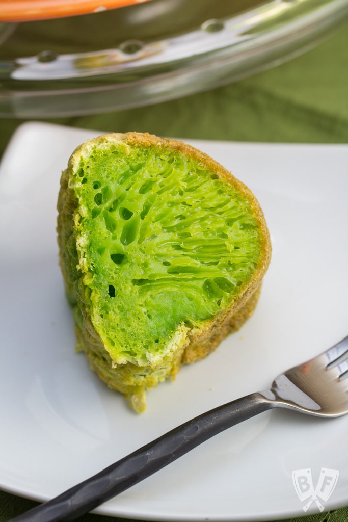 A slice of vibrant green Vietnamese honeycomb cake on a plate.