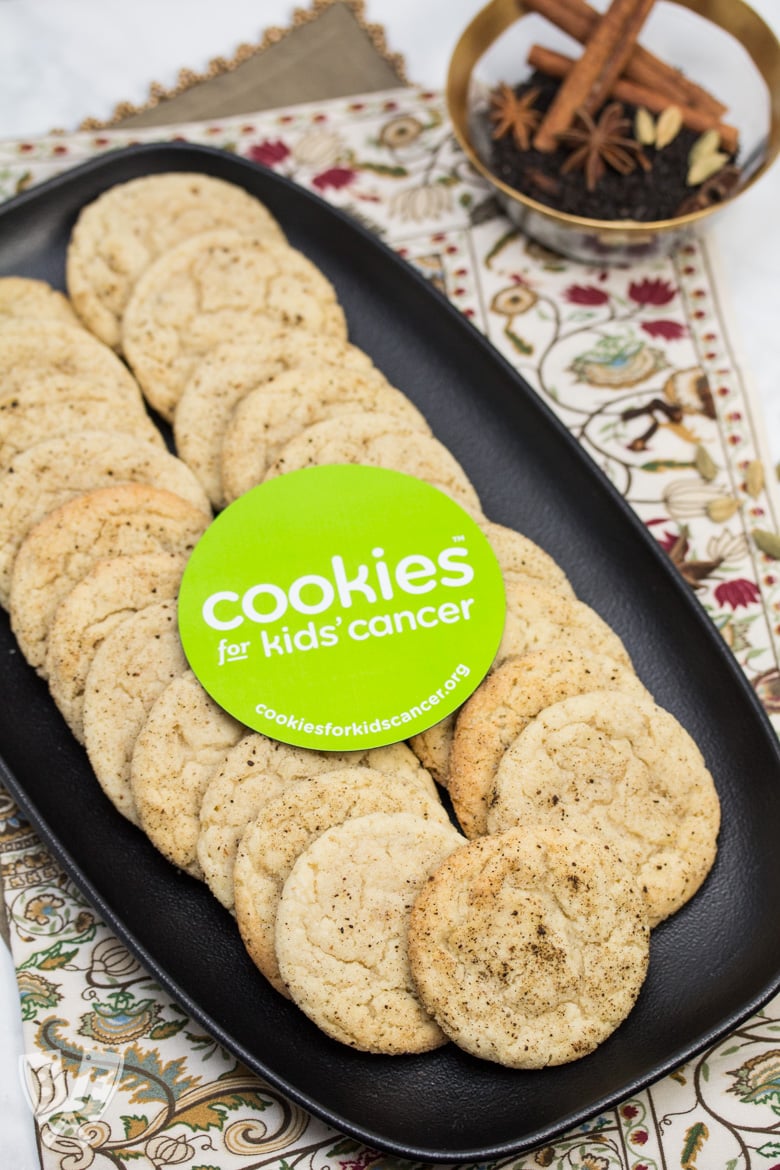 Overhead view of a platter of Chai Spiced Snickerdoodle Cookies with a bowl of whole spices in the background.