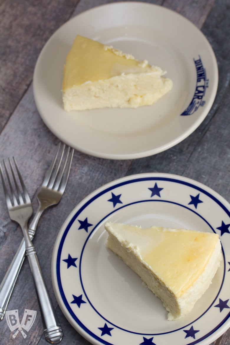 Overhead shot of two plates, each topped with a slice of Italian Cheesecake