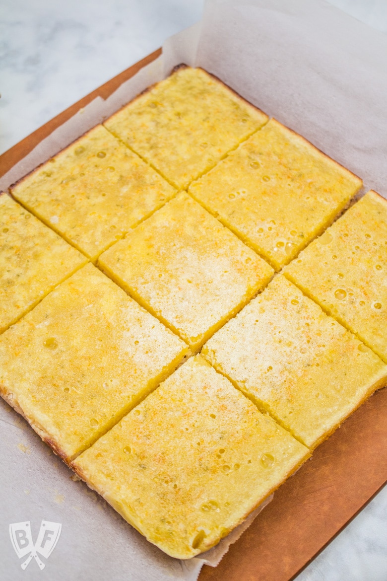 Overhead view of sliced dessert bars on a cutting board.